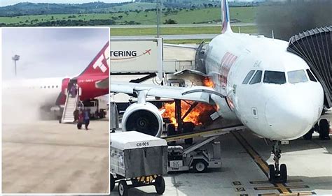 WATCH: Frightening moment plane bursts into flames as passengers flee ...