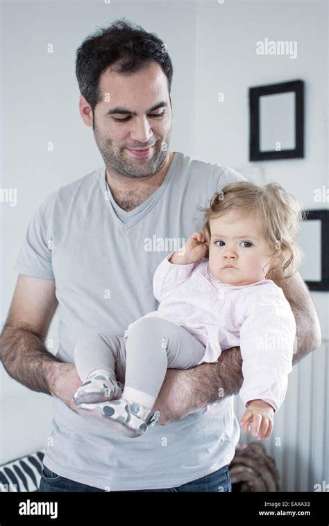 Father holding baby girl Stock Photo - Alamy