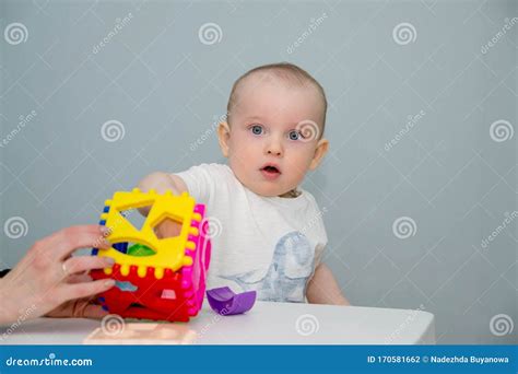 A Small Child Plays at the White Table in the Sorter Stock Photo - Image of childhood, sorter ...