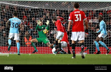 Manchester City goalkeeper Ederson saves a shot on goal by Manchester ...