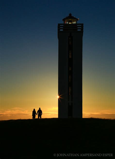 Couple walks around Kalfshamarsvik Lighthouse in northern Iceland at sunset | Iceland Photography