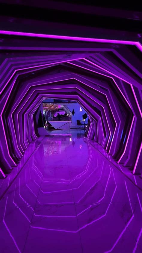 a tunnel with purple lights in the middle
