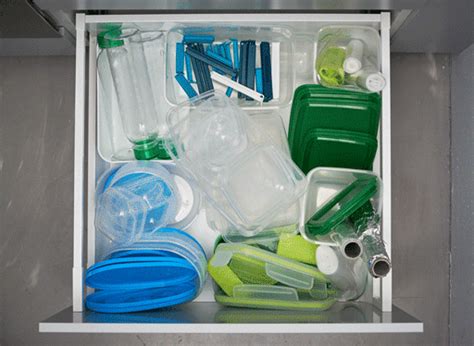 An animated GIF of organising a kitchen drawer full of plastic storage boxes, bottles, aluminium ...