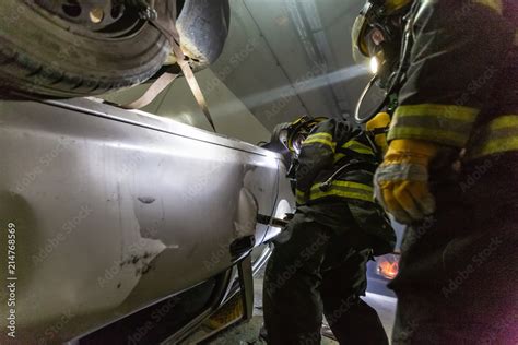 Car accident scene inside a tunnel, firefighters rescuing people from ...