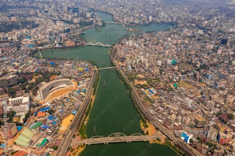 Aerial view of Hatir Jheel lake in Dhaka city center with city skyline ...