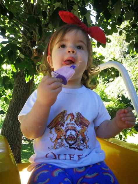 Todler girl eating yogurt popsicle. Queen t-shirt. Knot head lace. Rainbow leggins. Queen Tshirt ...