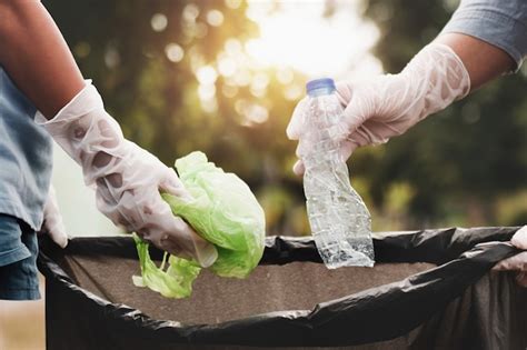 Premium Photo | Woman hand picking up garbage plastic for cleaning at park