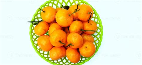 Jeruk Santang Madu. Citrus sinensis. Served in green basket on white ...