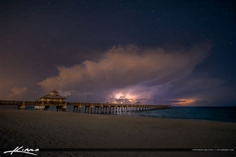 Juno Beach Pier Storm Over Ocean at Night | Royal Stock Photo