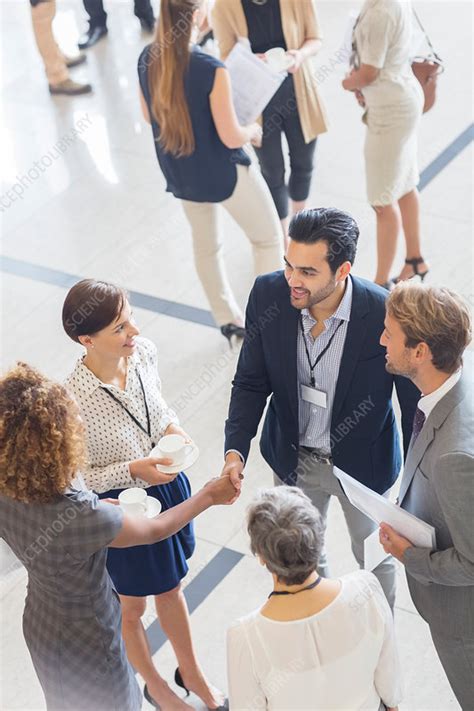 Business people shaking hands in office - Stock Image - F015/0232 - Science Photo Library