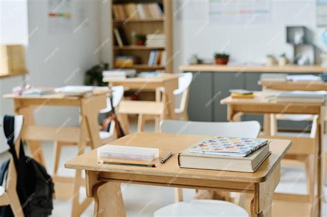 Premium Photo | Empty classroom with desks and books at school