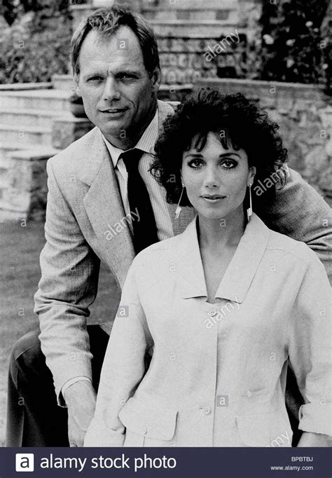 an old black and white photo of two people posing for the camera ...