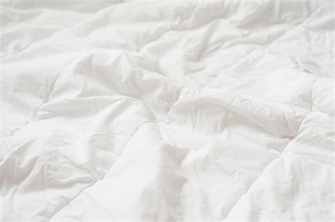 Premium Photo | Crumpled quilt white blanket texture. close up.