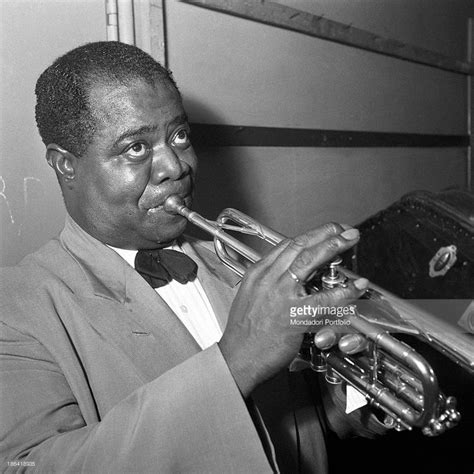 American trumpeter and singer Louis Armstrong playing the trumpet ...