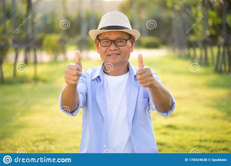 A Happy Old Man with Thumbs Up Smiling and Laughing in the Garden ...