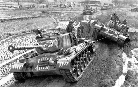 An M46 Patton assists another M46 that got stuck in the mud in Korea, during the spring of 1951 ...