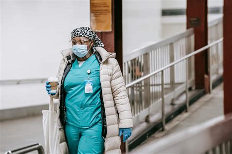 Black female nurse in uniform and protective mask on street · Free ...