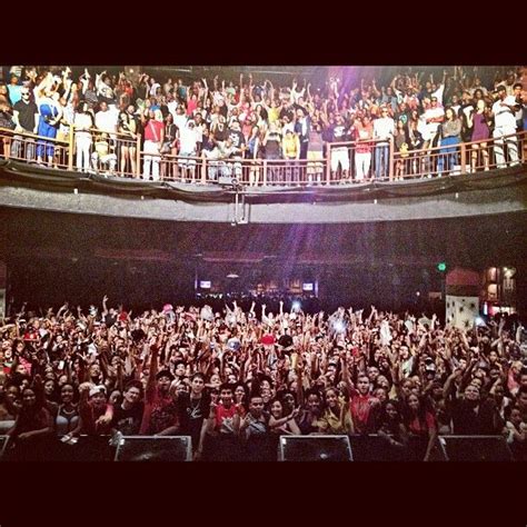 a large group of people standing on top of a stage in front of an audience