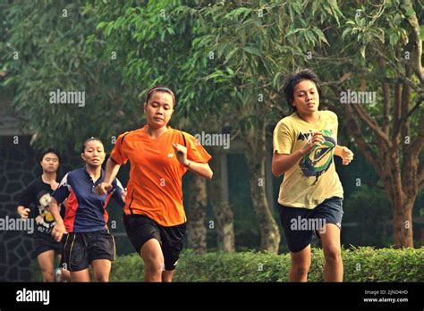 Young women badminton players are running circle a park during a training session at Jaya Raya ...