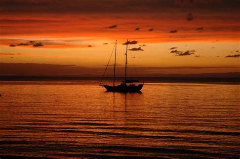 Silhouette of Boat on Sea during Sunset · Free Stock Photo