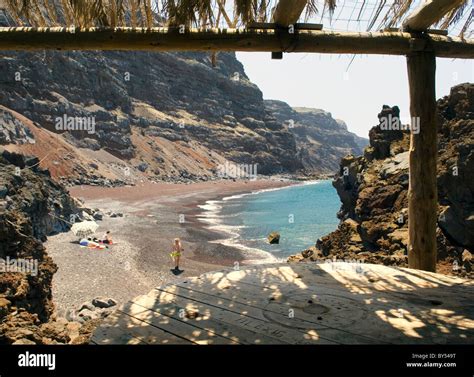 El Hierro, Canary Islands. The red black volcanic sand beach of the Playa del Verodal is the ...