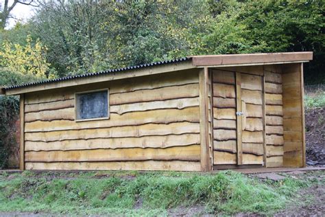 Externally insulate the existing scout hut and clad with waney edge ...