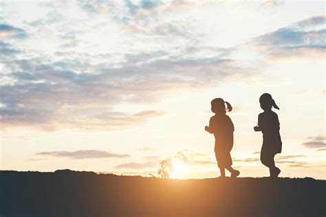 Sunset silhouette of children playing 1978123 Stock Photo at Vecteezy