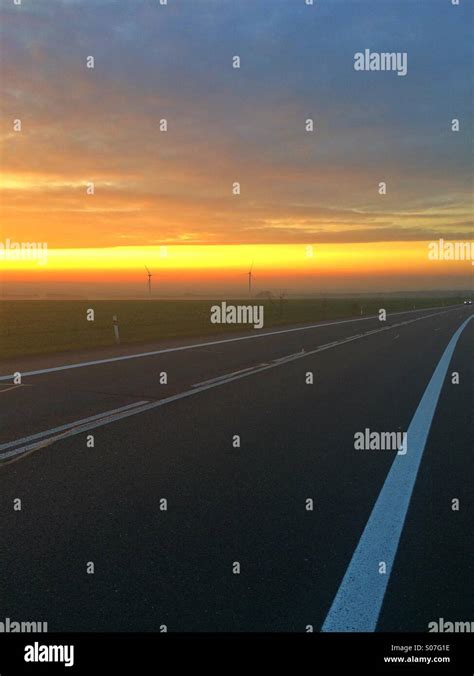 Empty road and dramatic sunset Stock Photo - Alamy