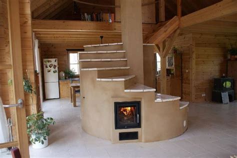 a living room filled with furniture and a fire place next to a spiral stair case