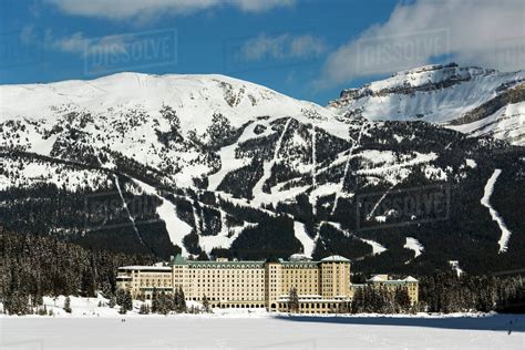 The Chateau Lake Louise in winter with the lake frozen and snow covered ...