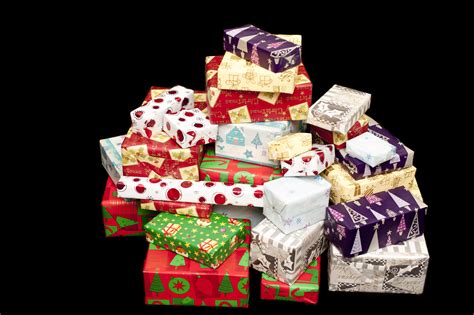 Photo of Pile of colorful Christmas gifts on black | Free christmas images