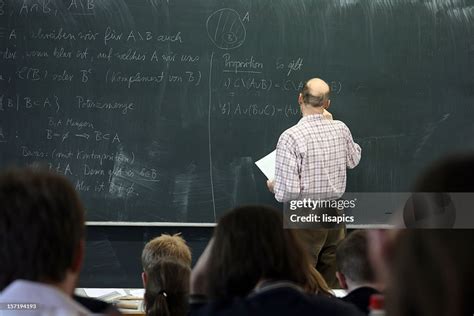 Teacher Writing On The Board For Math High-Res Stock Photo - Getty Images