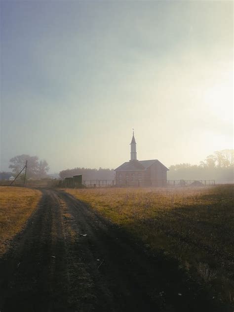 Brown Dirt Road Between Green Grass Field · Free Stock Photo