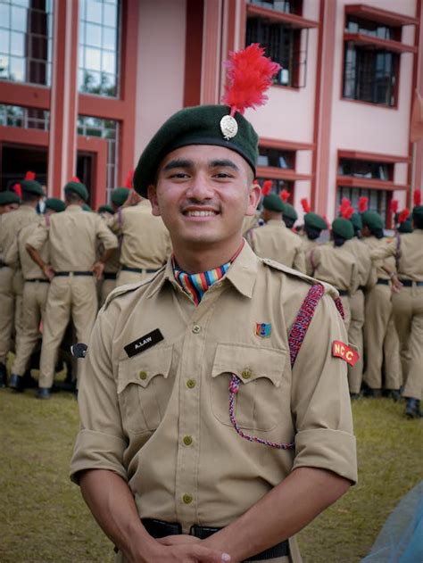 A Young Man in NCC Cadet Uniform Smiling at the Camera · Free Stock Photo