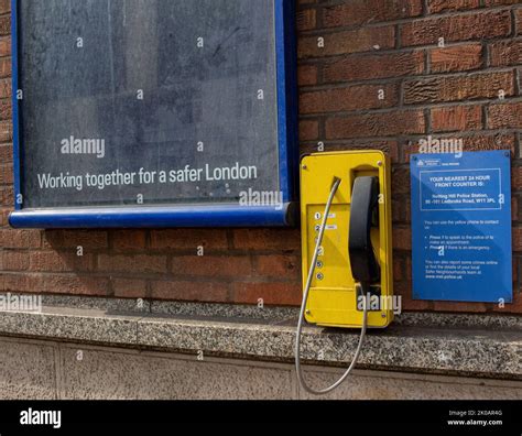 Telephone of wall of Kensington police station, West London Stock Photo ...