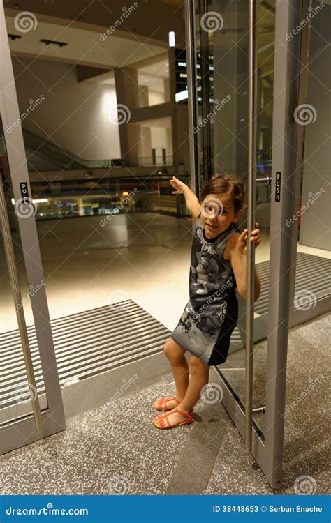 Girl Holding Open Glass Door Royalty-Free Stock Photography ...