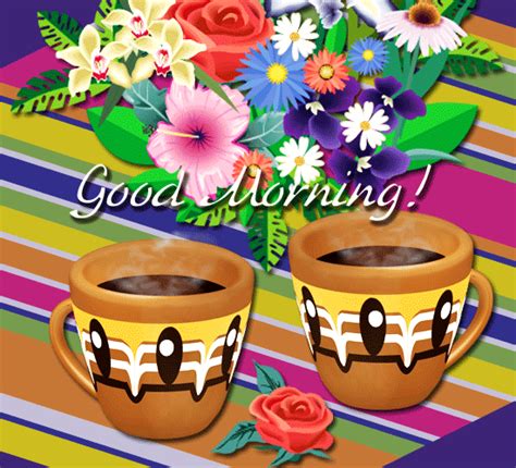 two coffee cups sitting next to each other on top of a striped table cloth with flowers