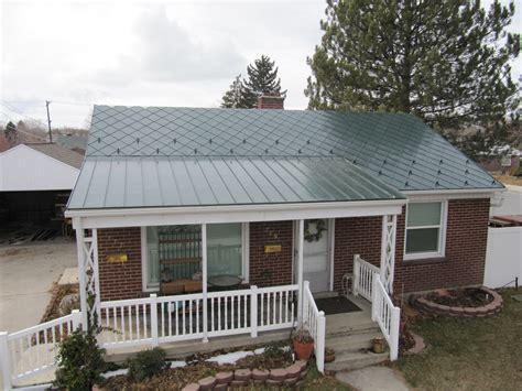 Beautiful green steel metal roof with standing seam, diamond shingles and snow hooks to match ...