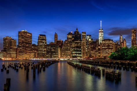 the city skyline is lit up at night