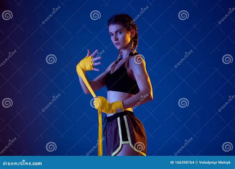 Fit Caucasian Woman in Sportswear Boxing on Blue Studio Background in ...