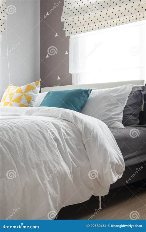 Colorful Pillows on White Bed in Modern Bedroom Stock Image - Image of ...