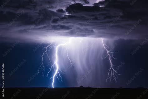 A bolt of lightning strikes in a storm. Thunderstorm in the night sky Stock Photo | Adobe Stock