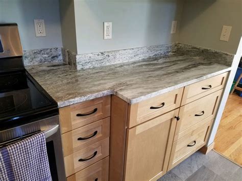 Brown Fantasy Granite counter top. Waypoint Cabinets in Maple color Rye.