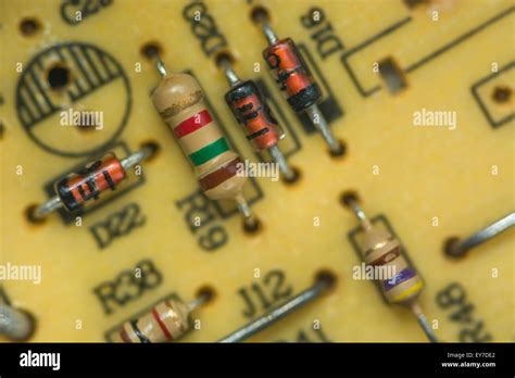 Macro-photo of carbon resistors and diodes on a through-hole printed circuit board (PCB ...