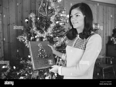 Barbara Jane Mackle trims the Christmas tree at her home in Miami, Dec. 18, 1969, one year after ...