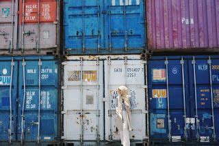 a person standing in front of some containers