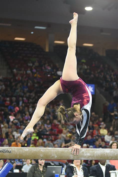 University of Denver gymnast Alix Angelopulo holds a back walkover on beam. Photo taken on March ...