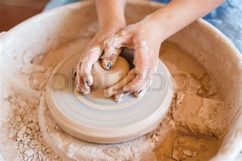 Female potter shaping a pot on pottery ... | Stock image | Colourbox