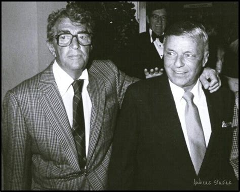 two men in suits and ties standing next to each other