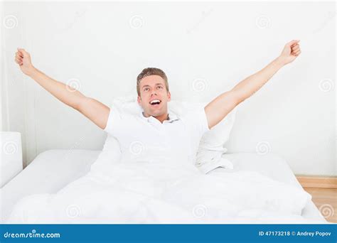 Man Waking Up in Morning and Stretching on Bed Stock Photo - Image of ...